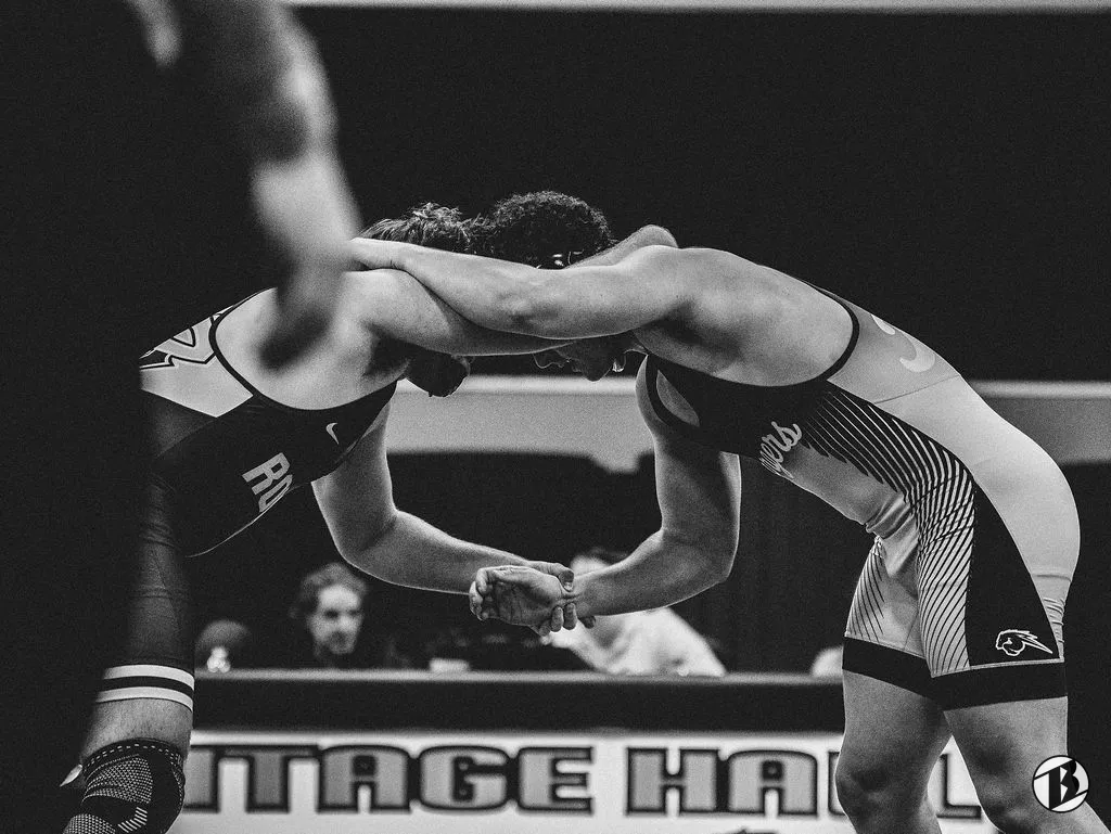 Two wrestlers lock up during a Heritage Hall dual meet